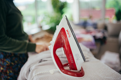 Woman ironing and folding her clothes
