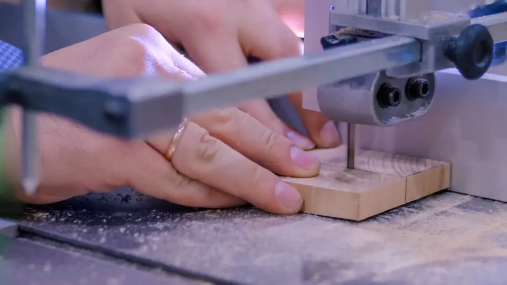 A close-up view of a piece of wood being cut