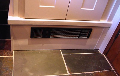 A heating appliance is installed in the base of linen cupboard