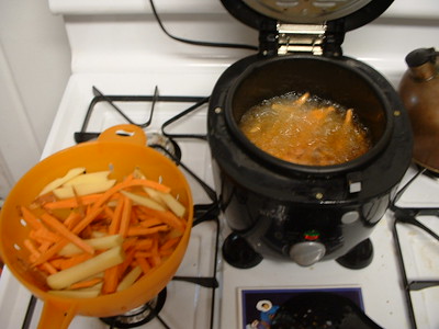 A kitchen appliance is used to cook potatoes