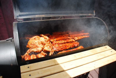 Chicken and pork ribs in the grill
