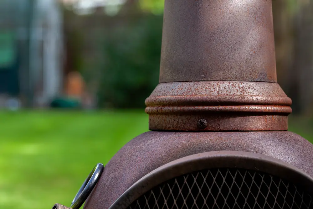 Close up of a rusted steel fireplace in the garden