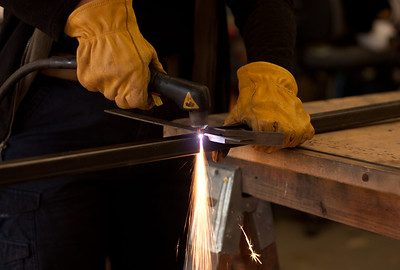 Metal working using an electric tool on steel and welding to fabricate a frame