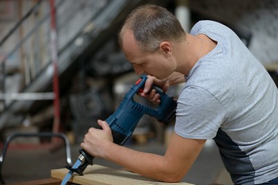 a carpenter cutting a piece of wood
