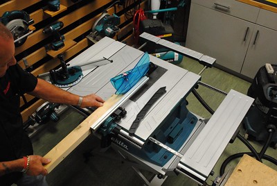 a carpenter cutting a wooden block