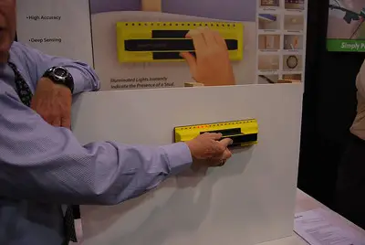 a man scanning the thickness of a plywood