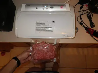 a man sealing burger for freezer storage
