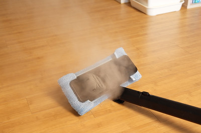 mopping the floor with a steamer