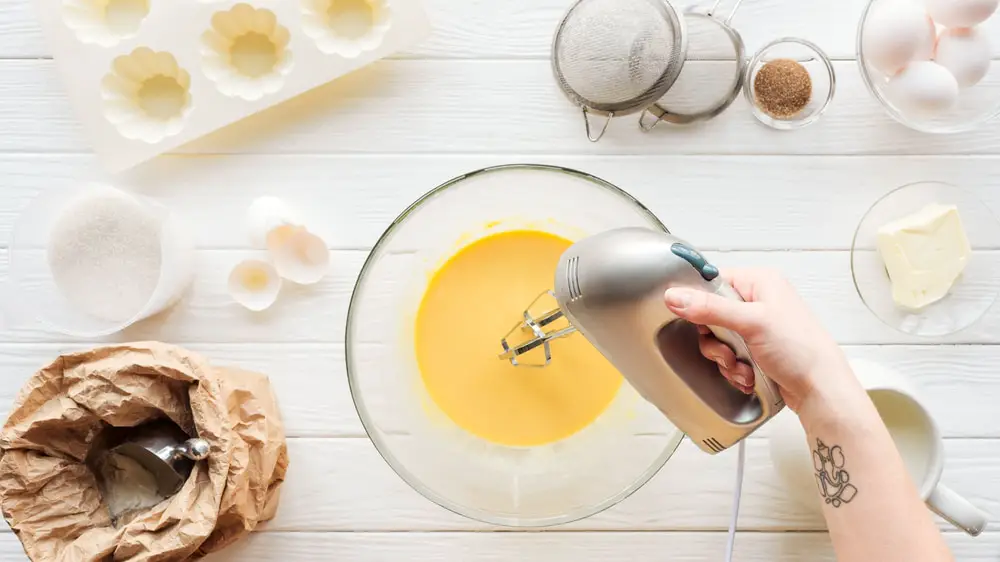 A pair of hands preparing ingredients for baking