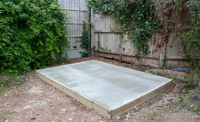 a-concrete-foundation-installed-in-a-small-backyard