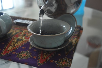 a-teapot-pouring-water-into-a-small-teacup