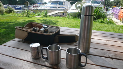 metal container for water and cups on the table