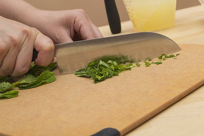 stainless-steel-tool-slicing-herbs-on-a-chopping-board